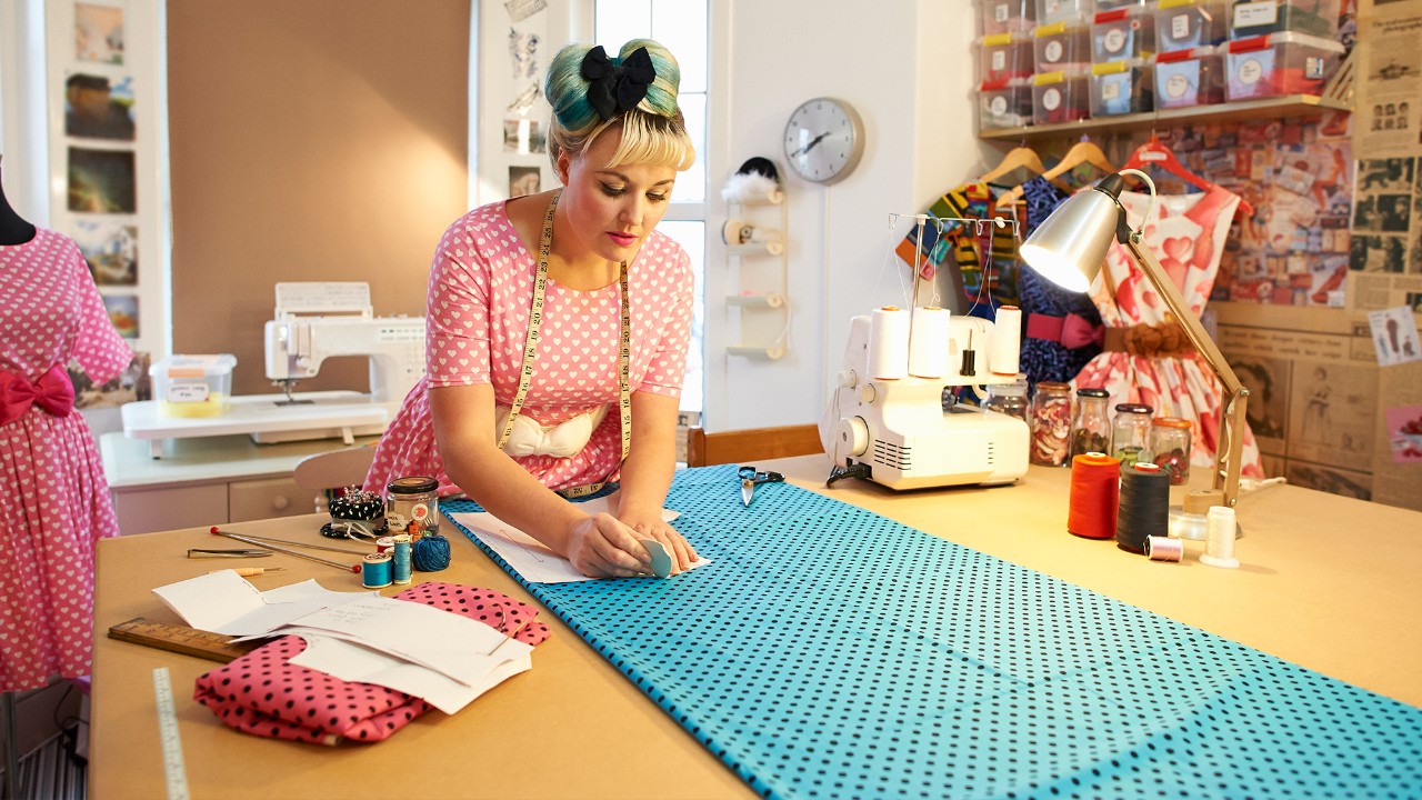 A woman is sewing clothes; image used for HSBC Malaysia getting financially fit article page.