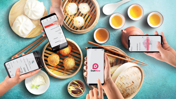 Four people taking pictures of food; image used for HSBC Malaysia Samsung Note 9 offer