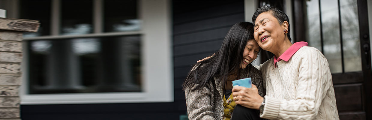 Adult woman and senior mother talking on front porch; image used for HSBC Malaysia Importance of an Emergency Fund page.