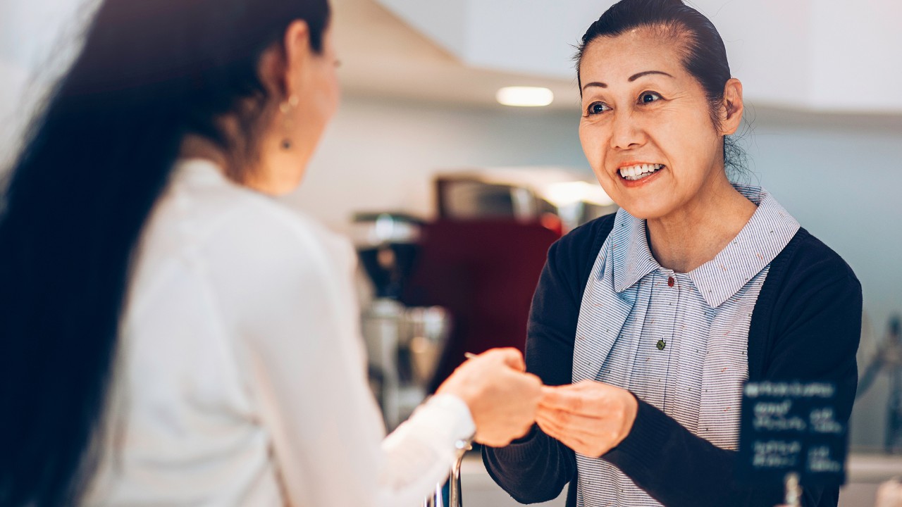 A woman paying with her card; image used for HSBC Malaysia Fees and charges page