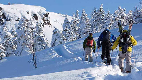 Three people are skiing; image used for HSBC Malaysia 7 great year end holiday destinations article