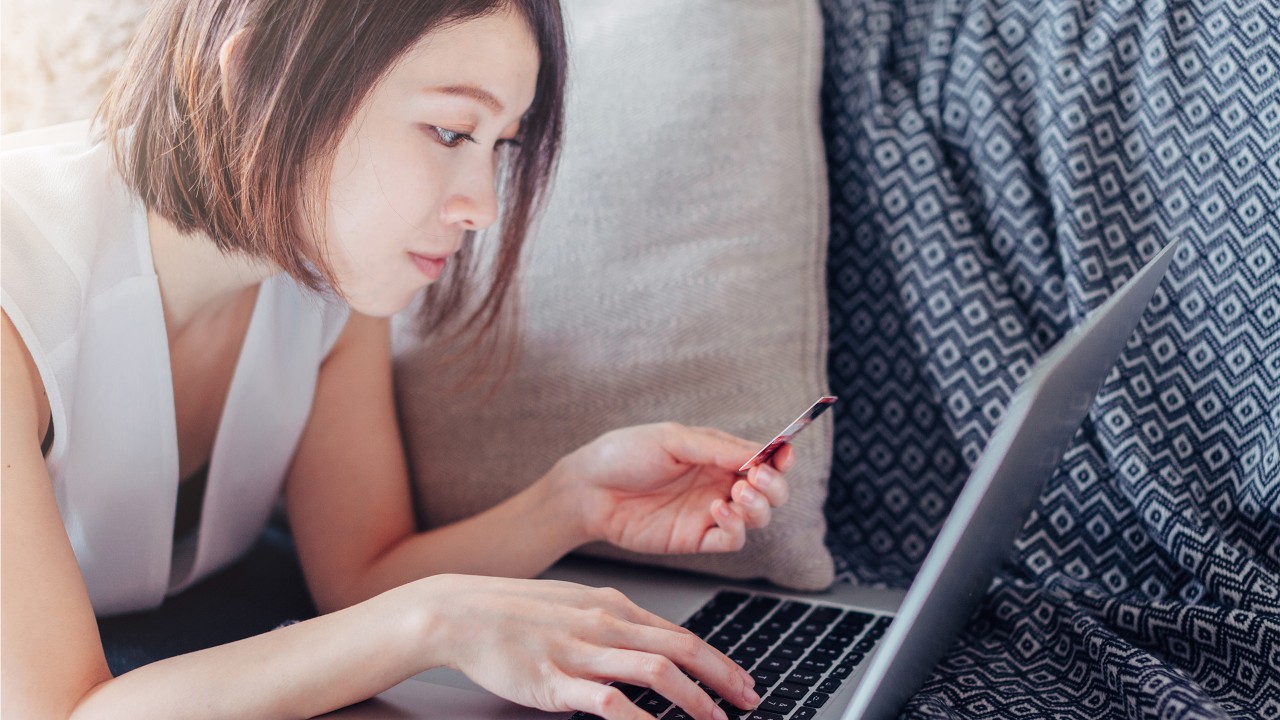 Woman and laptop above the sofa; image used for HSBC Malaysia Phishing article page.