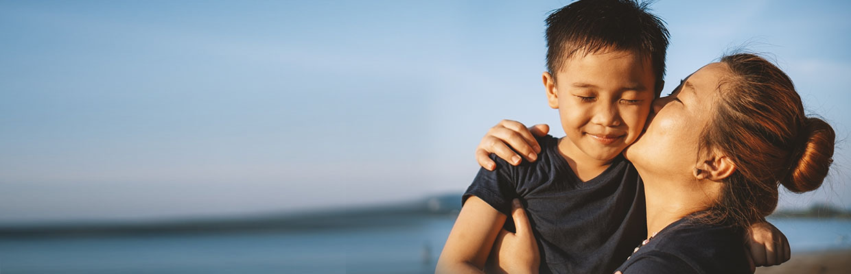 A mother kissing her son's cheek; image used for HSBC Malaysia Junior TopRate Savings page.