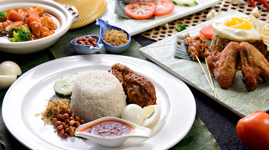 Many plates of food on a table; image used for HSBC Malaysia Best Ramadan Bazaars article