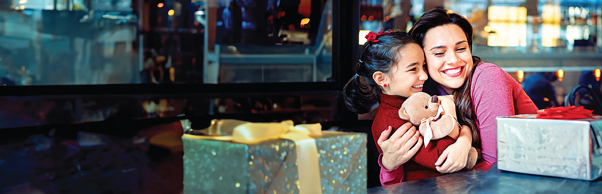 A woman using binoculars with shoppingbags; image used for HSBC Malaysia credit cards 2020 cash back offer