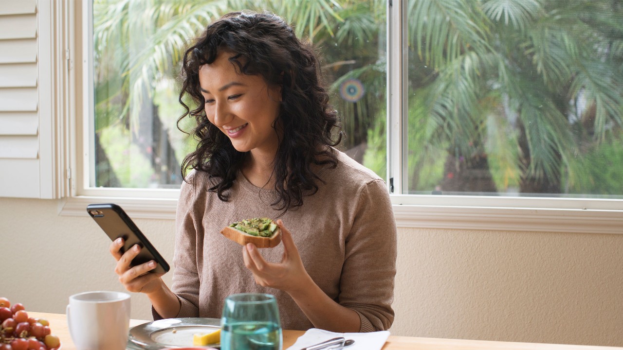 Woman eating toast; image used for HSBC MY getting into a savings habit article page