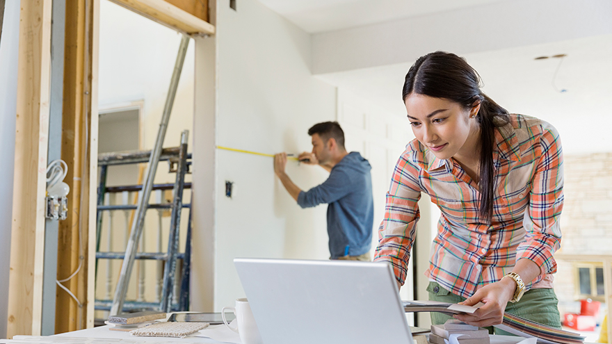 A woman and a man are fixing a house; image used for HSBC Malaysia How to Spend Money Wisely article