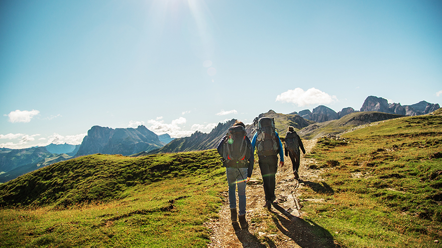 Three people are hiking; image used for HSBC Malaysia How to Spend Money Wisely article