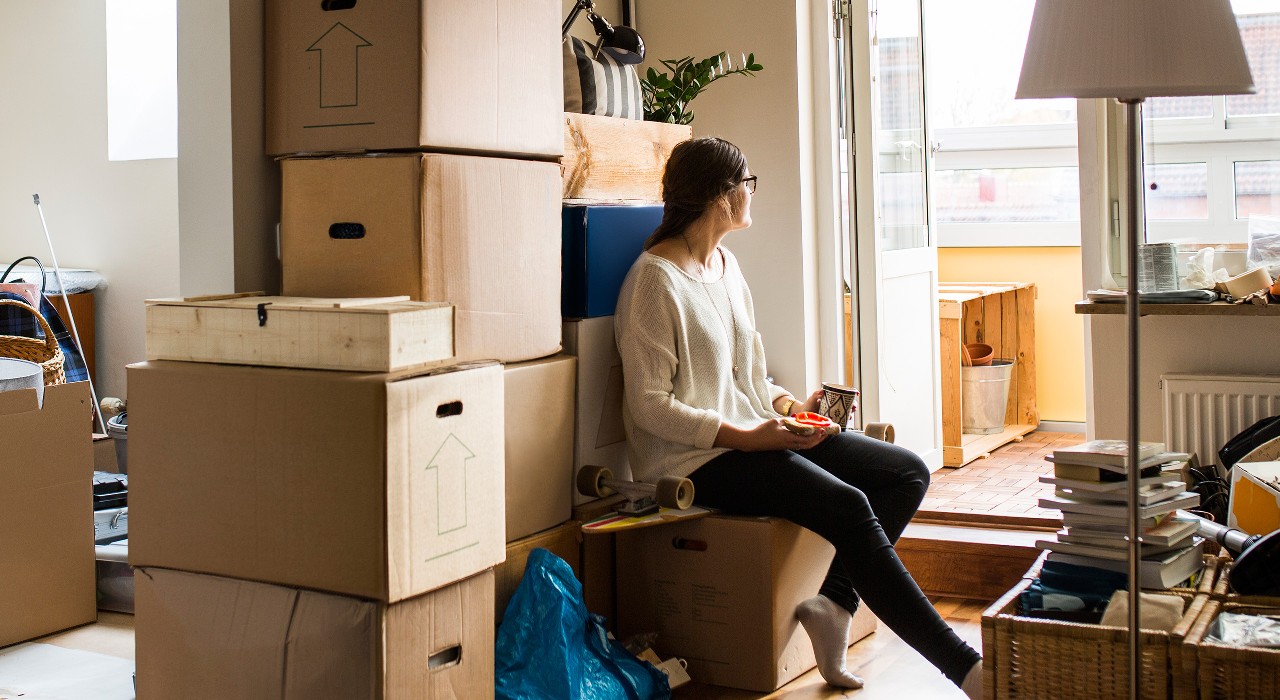 A woman is sitting in the living room looking through the window; image used for HSBC Malaysia Liquid Be a Savvy Online Shopper article