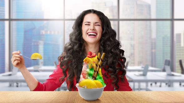 a woman is eating an ice cream happily;image used for Offer page