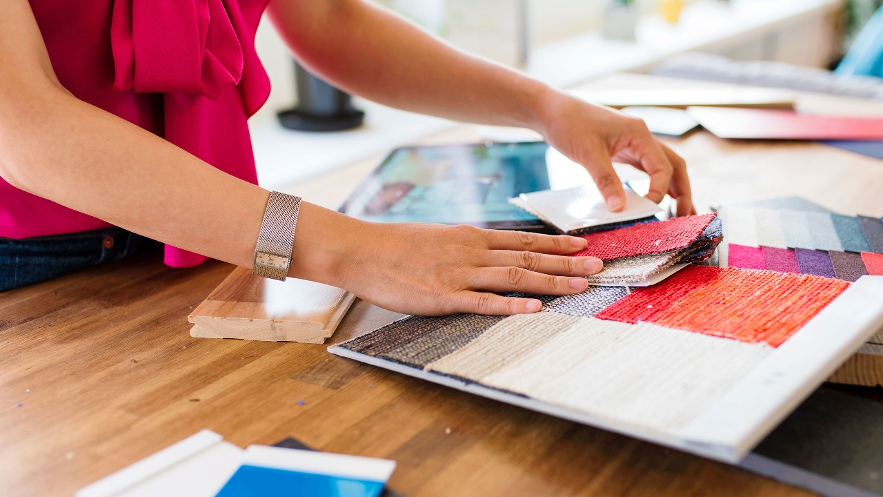 Small business owner checking the fabric in the shop; image used for HSBC Fusion Malaysia Products and services page