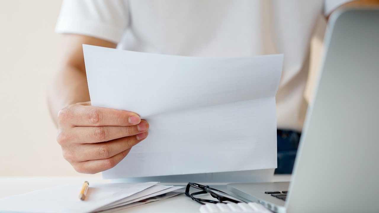 Small business owner holding invoice paper; image used for HSBC Fusion Malaysia Products and services page