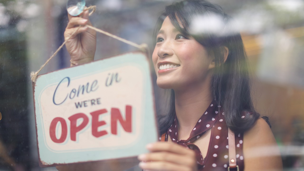 A shop owner opening her store ; image used for HSBC Fusion Malaysia homepage