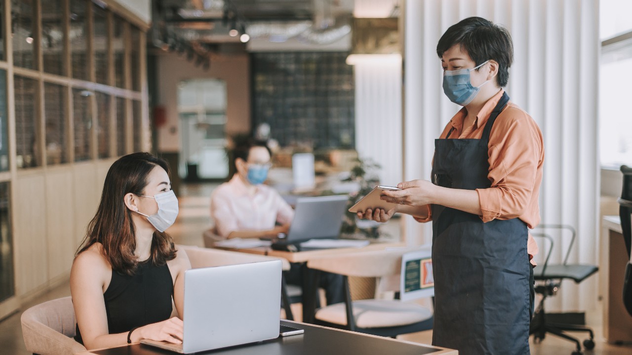 A small business owner is working in a restaurant ; image used for HSBC Malaysia Fusion ‘7 key questions you should ask before developing a post-COVID-19 business strategy ’ article.