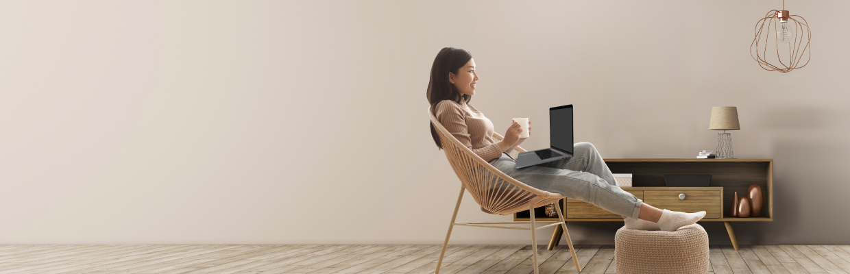 A female entrepreneur using digital banking on a chair; image used for HSBCnet upgrade for small business page.