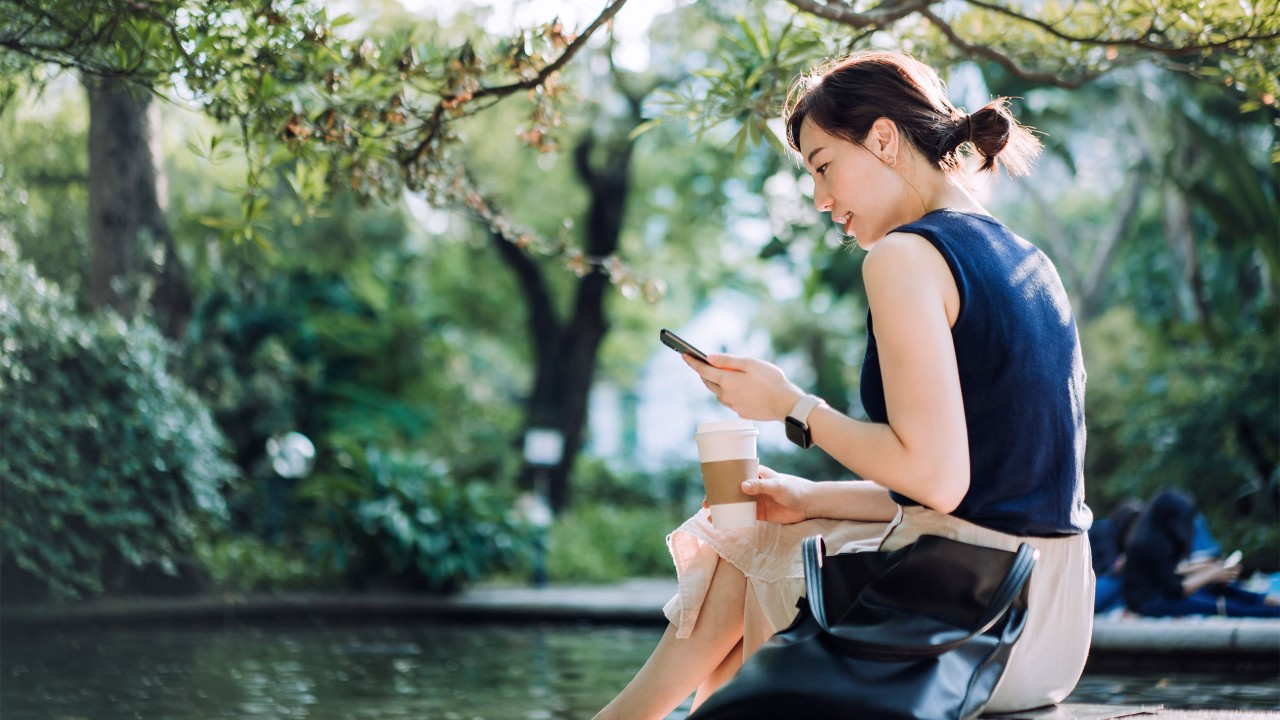 A woman is looking at her mobile phone; image used for HSBC Malaysia Fusion 'Work life balance for small business owners' article page.