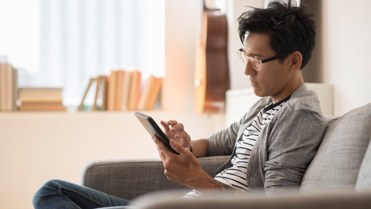 A man is using a tablet; image used for HSBC Malaysia Online banking