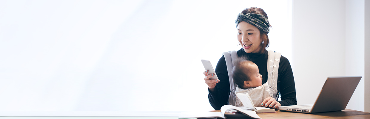 Mother with baby working at home; image used for HSBC Malaysia Remote Engagement Service page