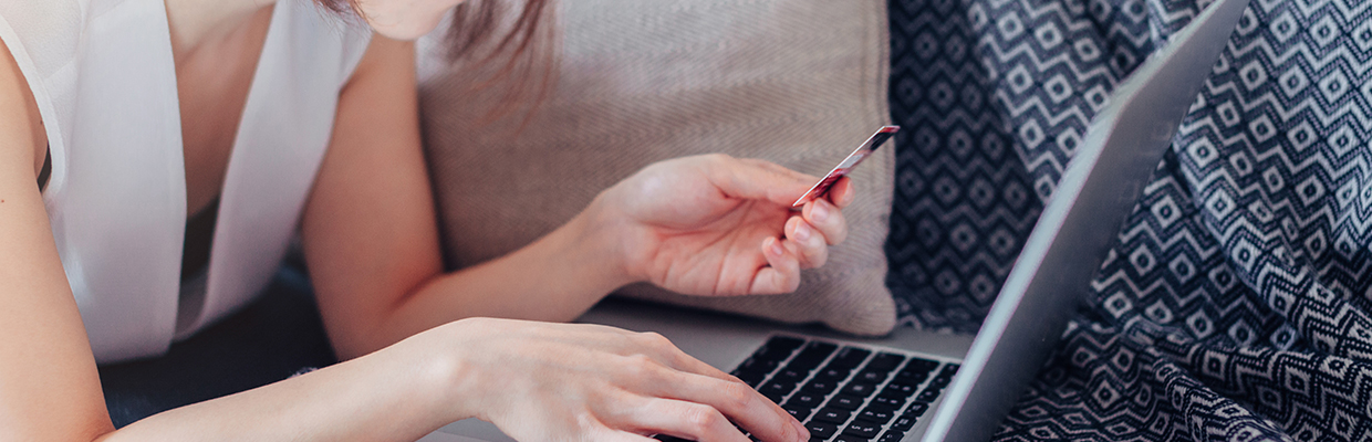 Woman and laptop above the sofa; image used for HSBC Malaysia Phishing article page.